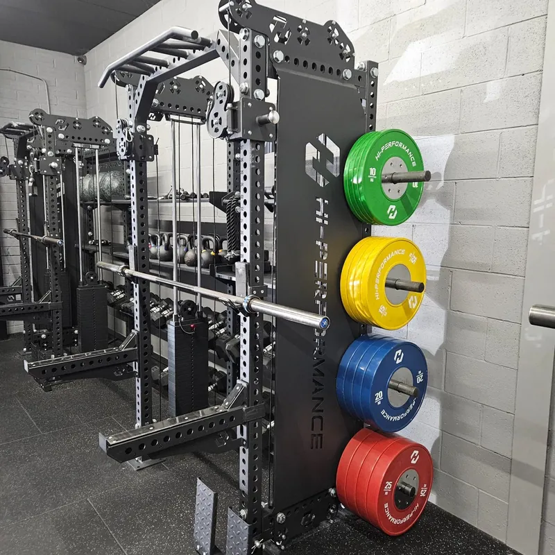 A power rack, weight plates and training equipment at Hi Performance.